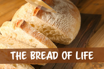 Wall Mural - Slicing of fresh bread on wooden cutting board closeup