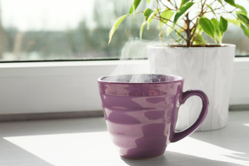 Poster - Cup of delicious hot drink on window sill