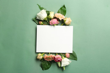 Poster - Beautiful flowers and green leaves as floral frame and paper card on color background