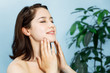 beautiful woman massaging her face. lymphatic massage.