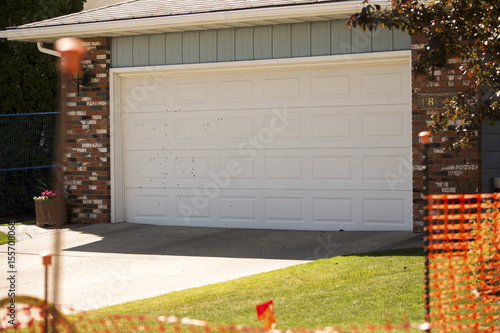 Bullet Holes Are Pictured On The Garage Door Across The Street