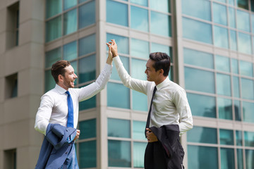 Canvas Print - Two Happy Business Men High Fiving Outdoors