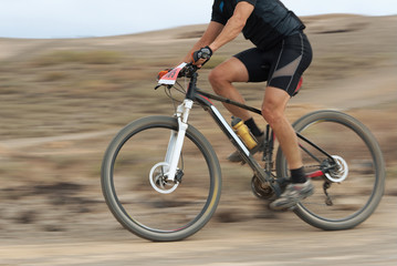 Wall Mural - Motion blur of a mountain bike race with the bicycle and rider at high speed