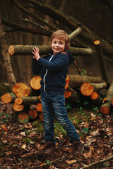 Wall Mural - little sweet lumberjack in autumn forest