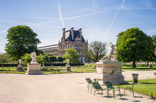 View Of The Tuileries Garden In Paris By A Sunny Morning With The Statues Of The Good Samaritan And Alexander Fighting In The Foreground And The Flore Pavilion Of The Louvre Palace In The Background