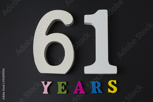 Poster Letters and numbers-sixty-one on a black background.