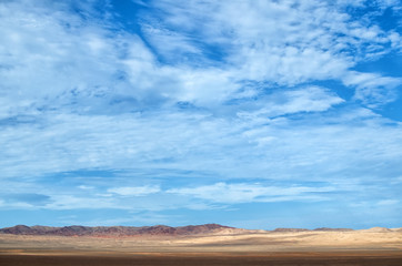 Wall Mural - Desert under blue cloudy sky