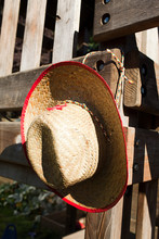 Cowboy Hat Hanging On Wooden Fence