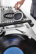 © goodmanphoto - a dj using a turntable and mixing board