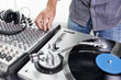© goodmanphoto - a dj using a turntable and mixing board