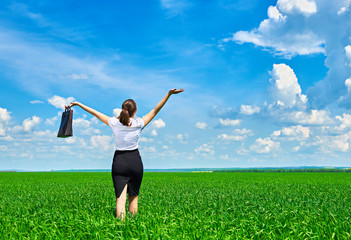 Business woman walk on green grass field outdoor and relax under sun. Beautiful young girl dressed in suit resting, spring landscape, bright sunny day