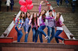 © AS Photo Family - Group of six girls having fun at hen party, with balloons under rain at stairs of city.