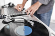 © goodmanphoto - a dj using a turntable and mixing board