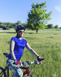 © Vitalii Nesterchuk - Young Woman Riding Mountain Bike in Wilderness.
