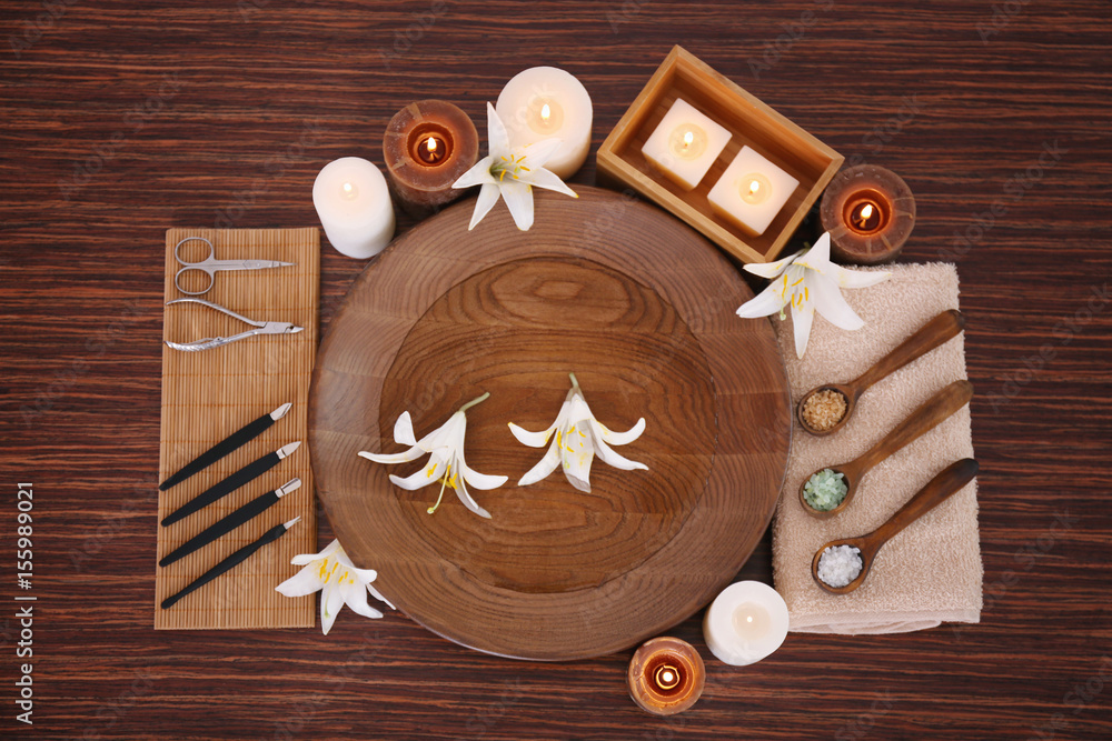 Beautiful spa composition of manicure tools and plate on wooden background