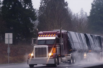 Wall Mural - Big burgundy rig in rain on high way