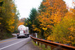 classic big rig with propane tank on winding autumn road