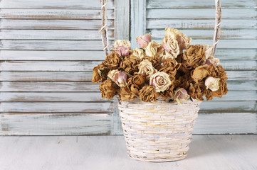 Wall Mural - Dried roses in basket against blinds