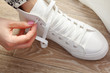 © fotofabrika - Woman tying shoelaces