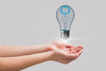 Sticker - Light bulb floating above hands with grey background