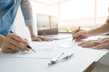 Wall Mural - Architects engineer discussing at the table with blueprint - Closeup on hands and project print, Team group on construciton site check documents and business workflow