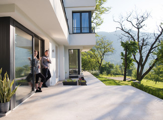 Wall Mural - couple enjoying on the door of their luxury home villa