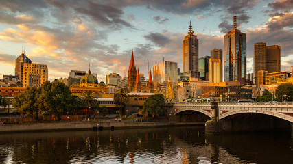 Wall Mural - Melbourne City, Yarra River, Princes Bridge with Reflection Cityscape Skyline background under dramatic Golden Sky Sunset, Australia