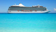 Side view of luxury cruise ship on beautiful blue ocean.