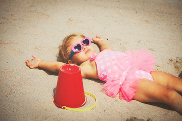 cute little girl play on sand beach