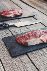 Sticker - Raw beef steak on dark wooden table background