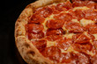 Pizza pepperoni on dark background