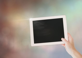 Sticker - Hand with tablet with sparkling light bokeh background