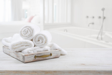 Wall Mural - Vintage drawer with white towels over blurred bathroom and bedroom