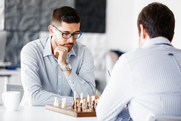 Portrait of two young man playing chess 