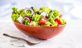 Fototapeta Tulipany - Salad. Vegetable salad. Spring vegetable salad.Fresh vegetable salad with tomatoes onion cheese and olives.