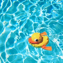 Yellow Rubber Duck On The Water In Hot Sunny Day. Summer Background For Traveling And Vacation. Holiday Idyllic.