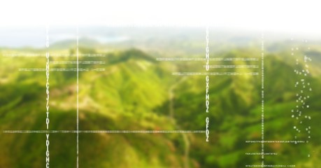 White code against green blurry mountains
