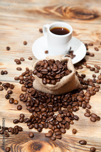 Obraz w ramie Coffee cup and beans on old kitchen table. Top view with copyspace for your text