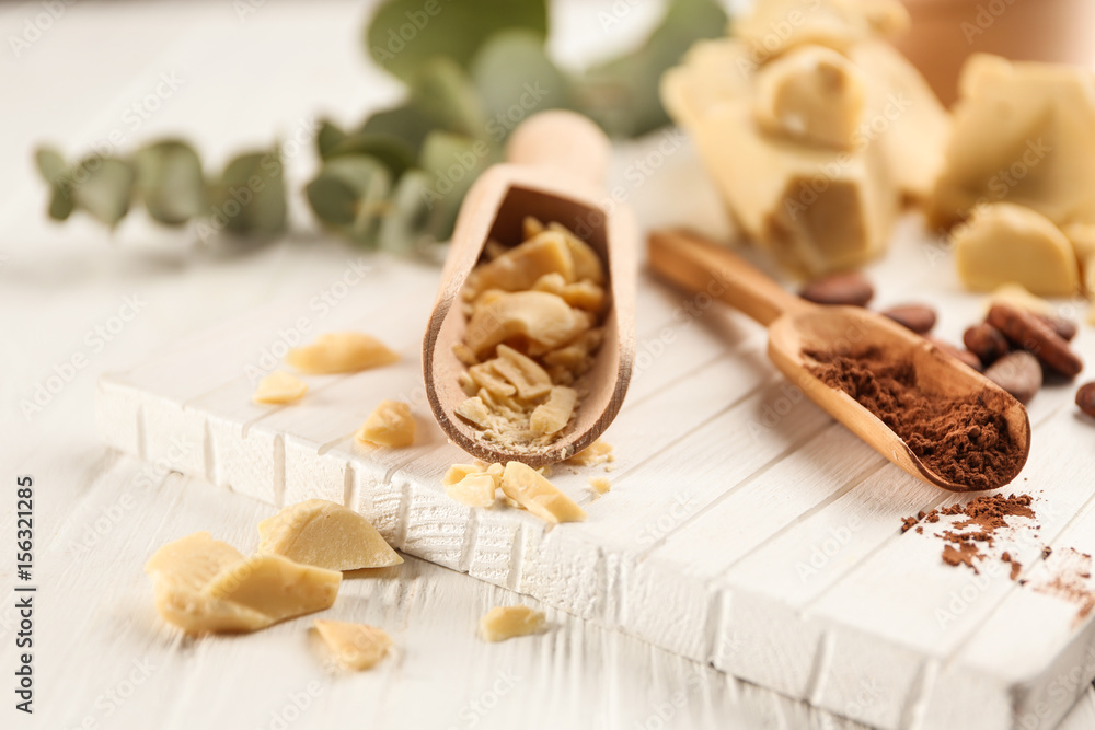 Cocoa butter and powder on wooden board