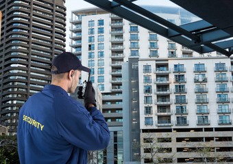 Wall Mural - security guard speaking with walkie-talkie. City