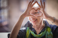 Cute Senior Old Woman Making A Heart Shape With Her Hands And Fingers