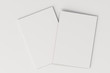 Two blank white closed brochure mock-up on white background