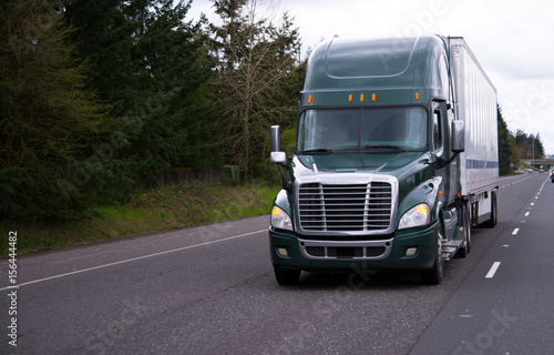 Modern Dark Green Semi Truck And Trailer On Straight Road This Modern Dark Green Semi Truck And Trailer On Straight Road