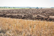Autumnal plowed field besides a stubble field