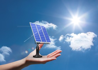 Wall Mural - Digital composite image of solar panel on hand against sky