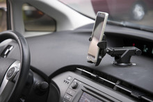 Cellphone Attached By Holder To The Car Dashboard