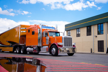 Wall Mural - Orange custom semi truck big rig trailer drive on truck stop