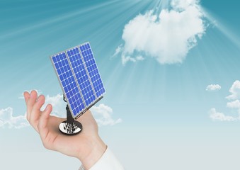 Canvas Print - Digital composite image of solar panel on hand against sky