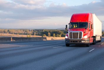 Wall Mural - Big rig red semi truck moving with trailer on wide highway