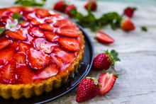 Delicious Sponge Cake With Jelly And Fresh Strawberries On A Wooden Background.